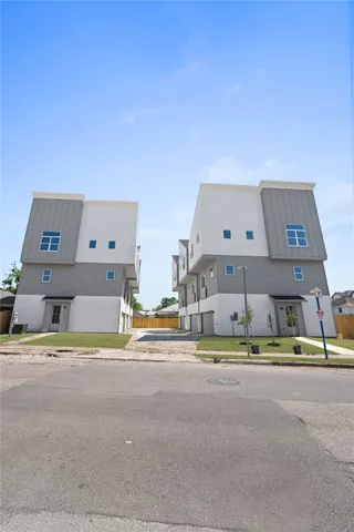 a view of building with road and parking space