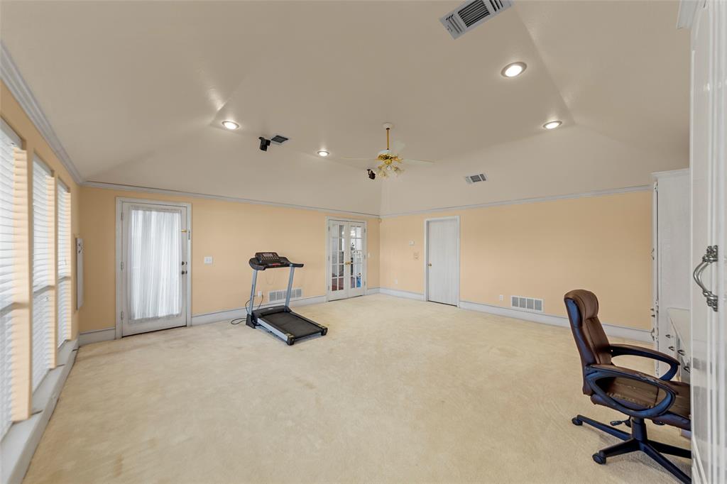 3308 North Spring Drive Richardson, TX 75082 - Photo 15 of 38 Originally designed as a model home upgrade, the converted garage now serves as a spacious third living area offering incredible flexibility. With its vaulted ceiling, recessed lighting, and abundant natural light, this expansive space feels open and inviting. Ideal as a game room, media room, home office, fitness studio, or playroom, it provides endless possibilities to fit your lifestyle needs. A rare bonus space that adds both function and versatility to the home.