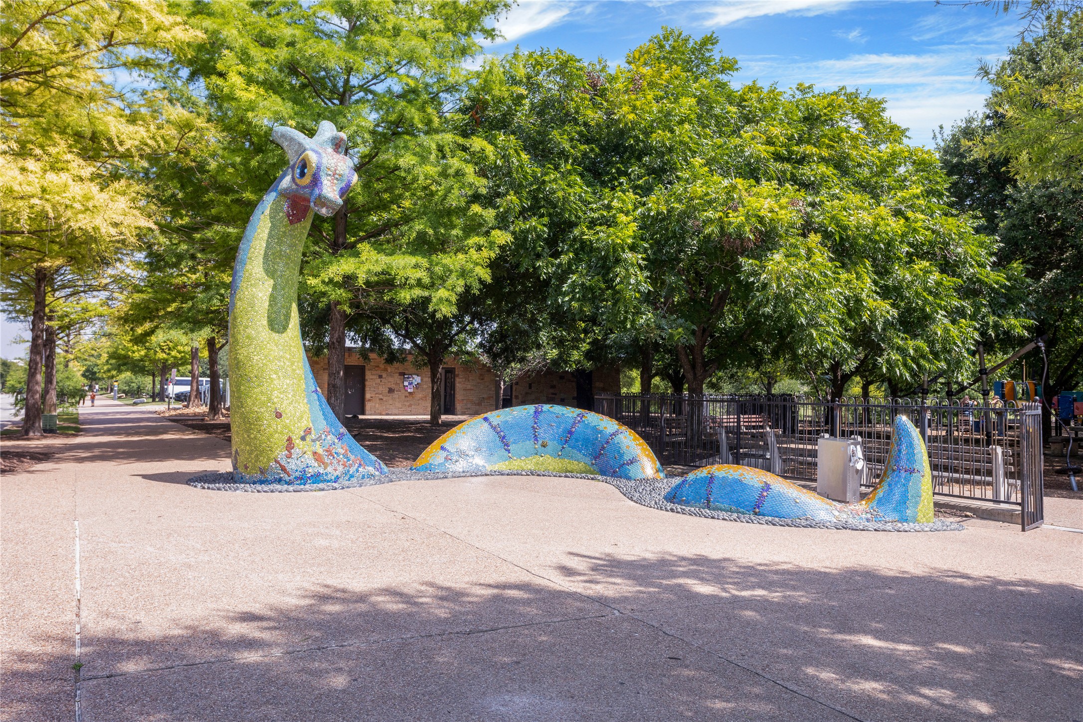 2805 McCurdy Street, Unit 14 Austin, TX 78723 - Photo 30 of 40 A whimsical mosaic sculpture adorns the park, inviting playful interactions amidst green trees and a paved walkway.