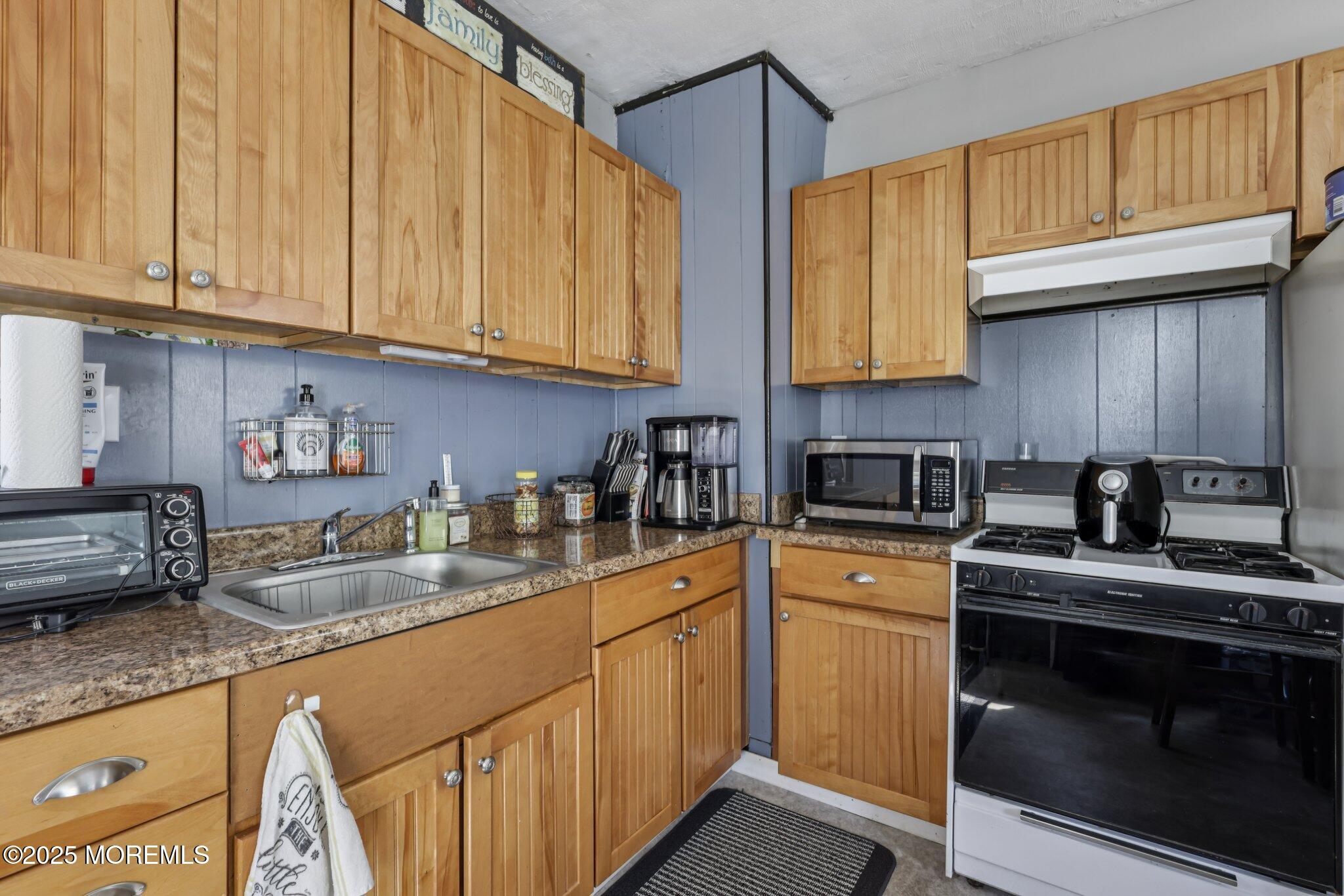 16 Reimer Street Raritan, NJ 08869 - Photo 19 of 30 a kitchen with stainless steel appliances granite countertop a sink a stove and cabinets