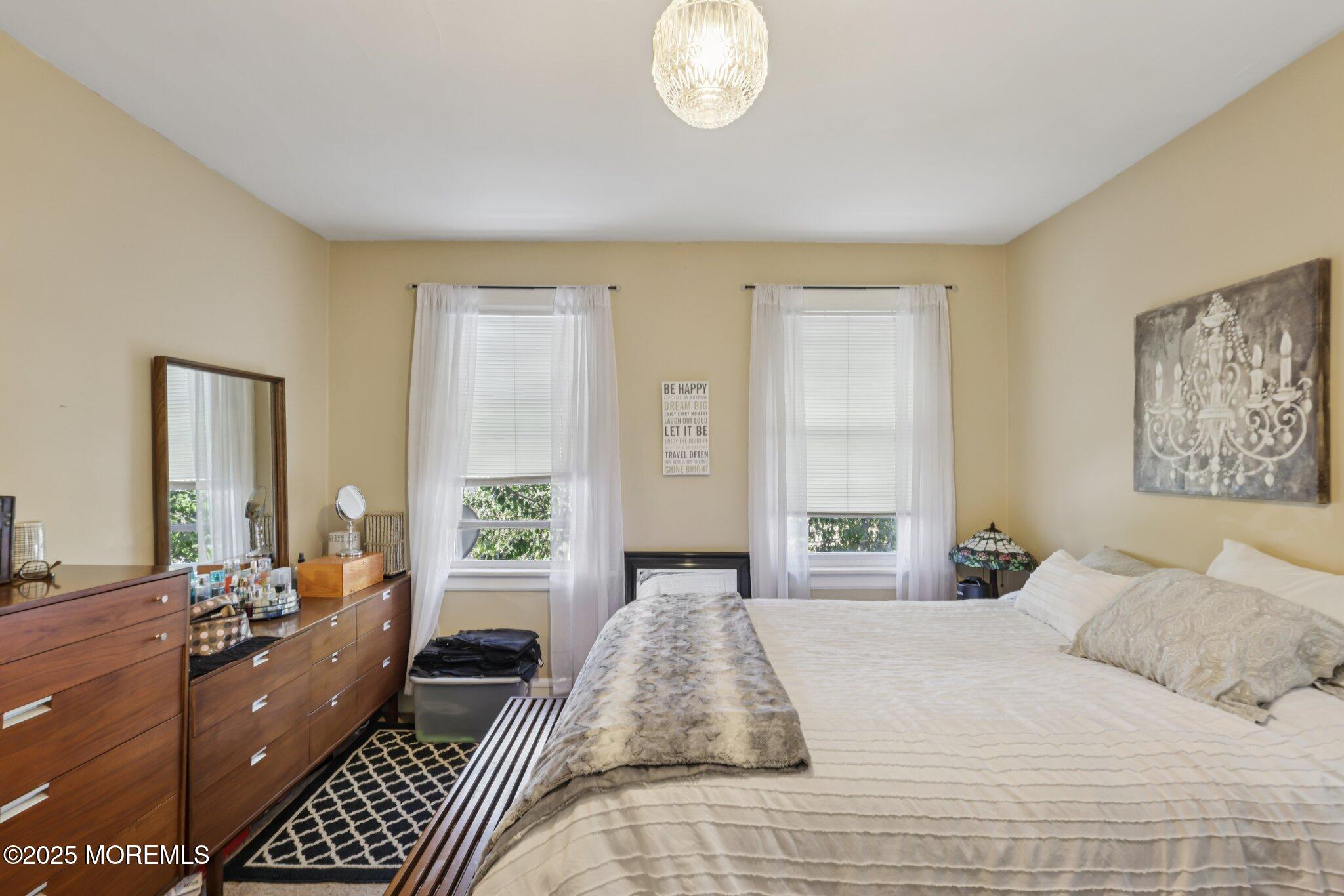 16 Reimer Street Raritan, NJ 08869 - Photo 21 of 30 a bedroom with a large bed and a chandelier