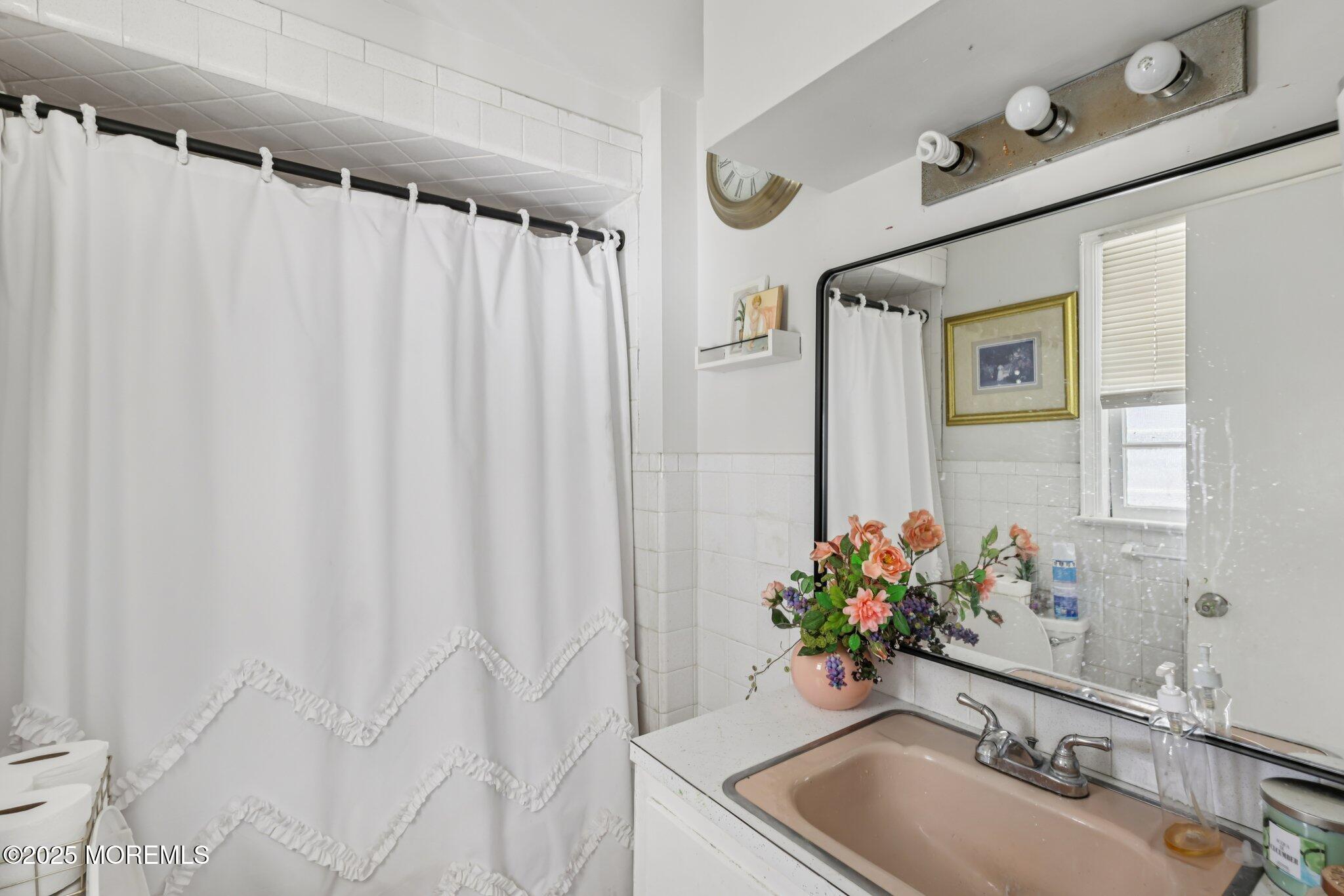 16 Reimer Street Raritan, NJ 08869 - Photo 8 of 30 a bathroom with a sink and a mirror