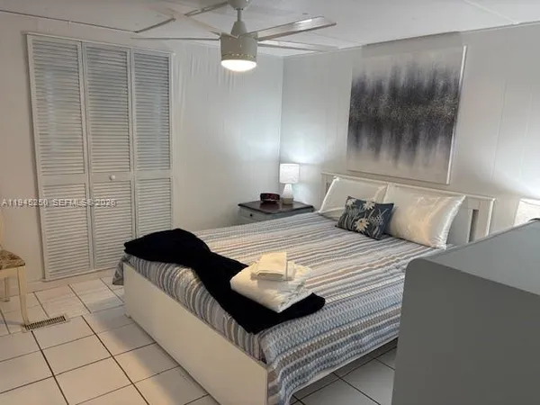 a bedroom with a bed and a shower