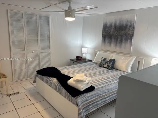 a bedroom with a bed and a shower