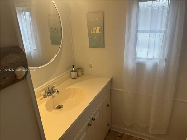 a bathroom with a sink and mirror