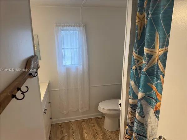 a bathroom with a toilet and shower