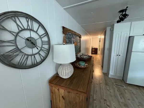a view of a livingroom with furniture and hardwood floor