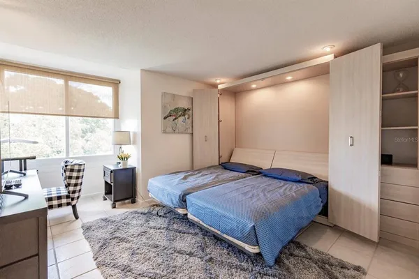 a bedroom with a bed and window