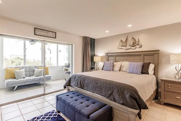 a bedroom with a bed and glass window