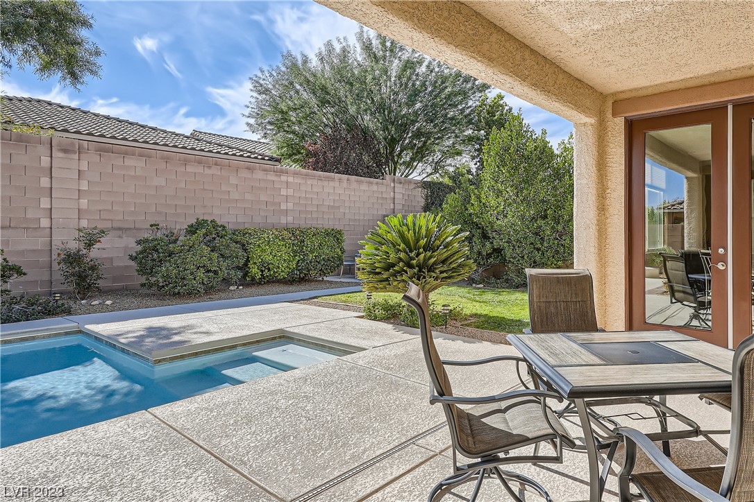 7421 Manse Ranch Avenue Las Vegas, NV 89179 - Photo 38 of 50 The covered patio is protected on three sides.