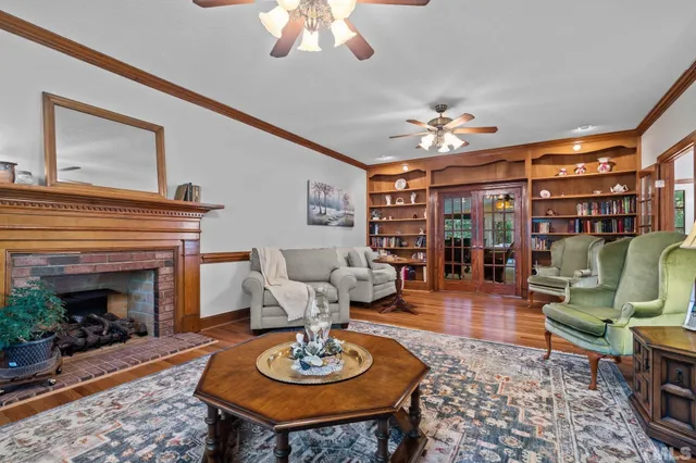 a living room with furniture a fireplace and a chandelier