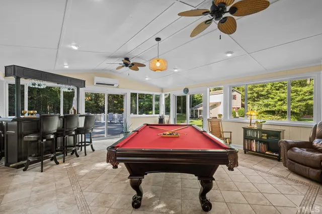 a room with furniture and pool table