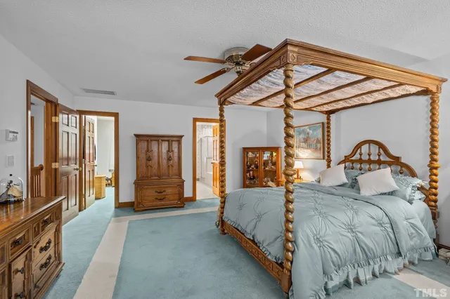 a bedroom with a bed a mirror and furniture