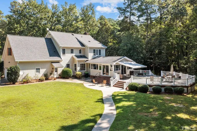 a front view of a house with swimming pool and sitting area