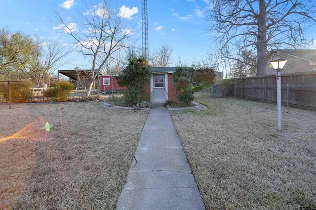 a view of backyard with large trees