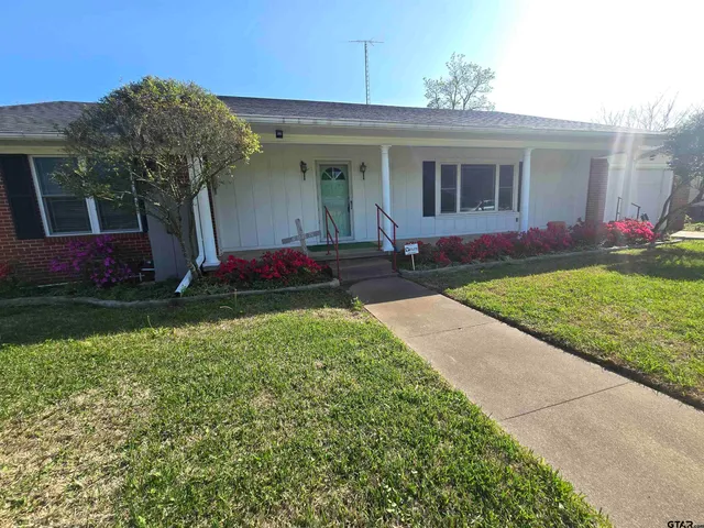 a front view of house with yard and green space