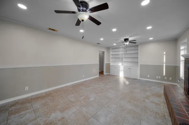 an empty room with a empty space and windows