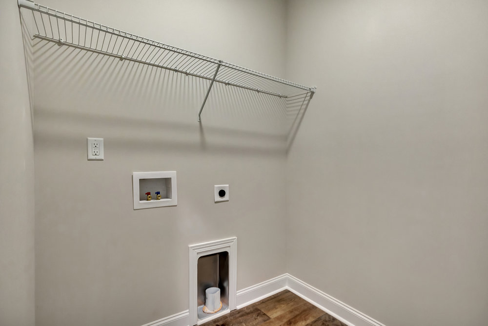 118 Bonaire Point Anderson, SC 29621 - Photo 12 of 23 This dedicated laundry space features convenient hookups and practical shelving for efficient organization.