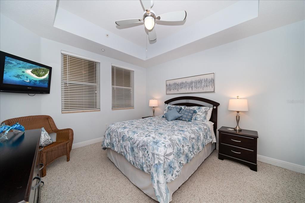 17735 Gulf Boulevard, Unit 304 Redington Shores, FL 33708 - Photo 14 of 66 a bedroom with a bed and a chandelier