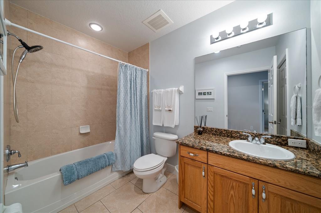 17735 Gulf Boulevard, Unit 304 Redington Shores, FL 33708 - Photo 17 of 66 a bathroom with a granite countertop sink toilet and shower
