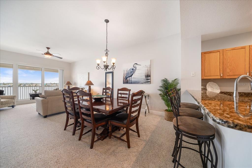 17735 Gulf Boulevard, Unit 304 Redington Shores, FL 33708 - Photo 23 of 66 a view of a dining room and livingroom with furniture wooden floor a chandelier