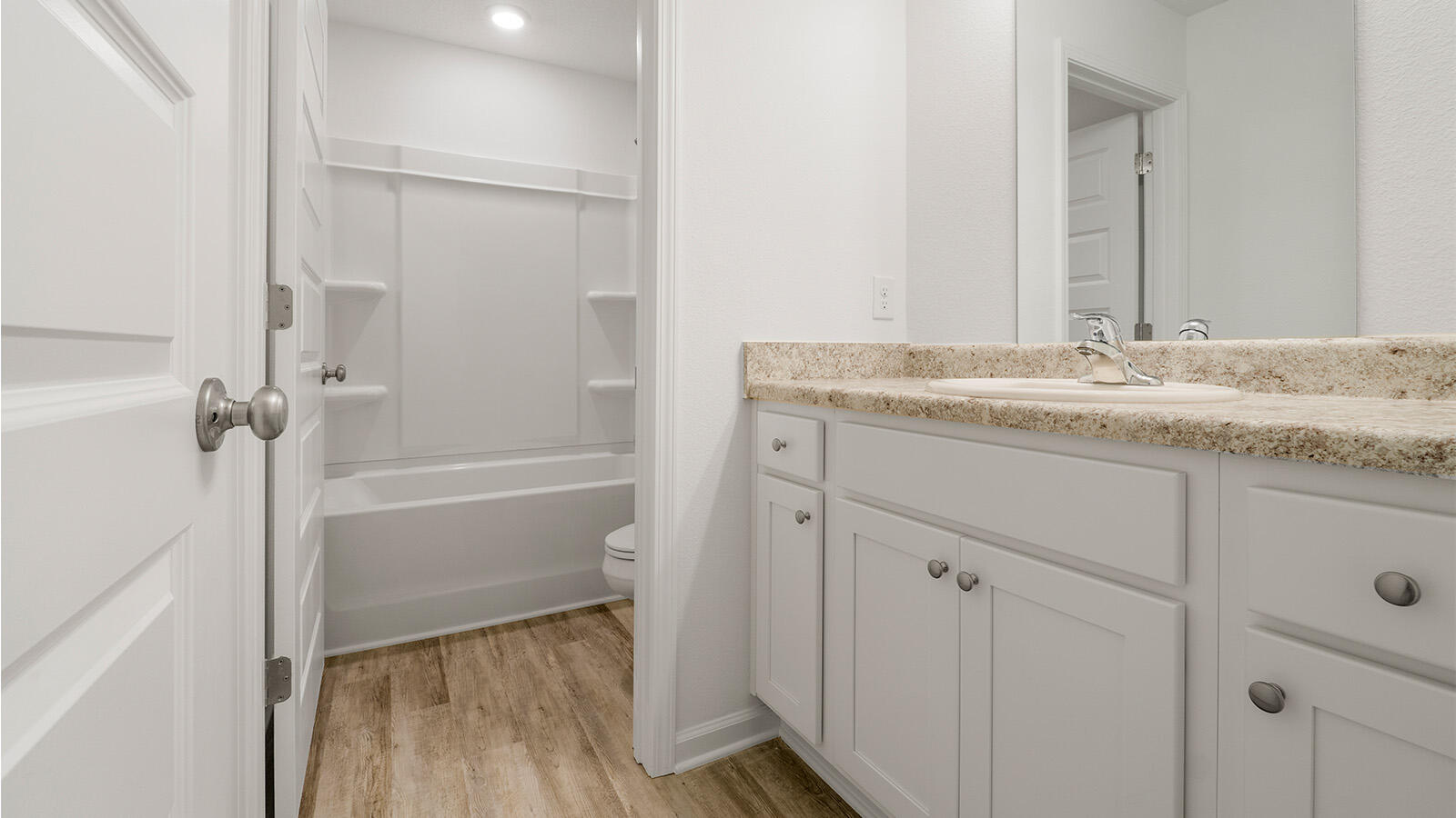 52 Elderberry Street Freeport, FL 32439 - Photo 20 of 36 a bathroom with a granite countertop sink and a mirror