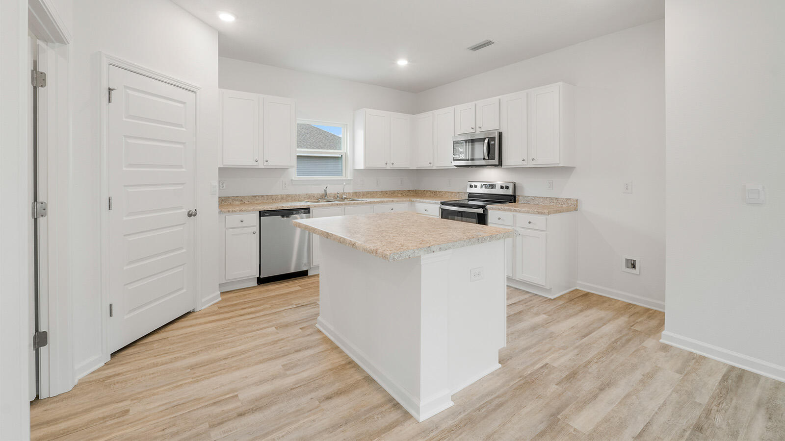 52 Elderberry Street Freeport, FL 32439 - Photo 5 of 36 a kitchen with stainless steel appliances granite countertop a stove top oven a sink and white cabinets