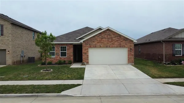 a front view of a house with a yard and a garage