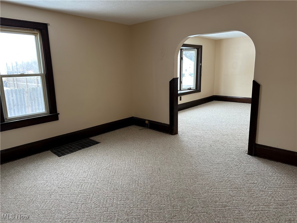 60 Taylor Road Barberton, OH 44203 - Photo 7 of 35 Unfurnished dining room with light carpet and plenty of natural light