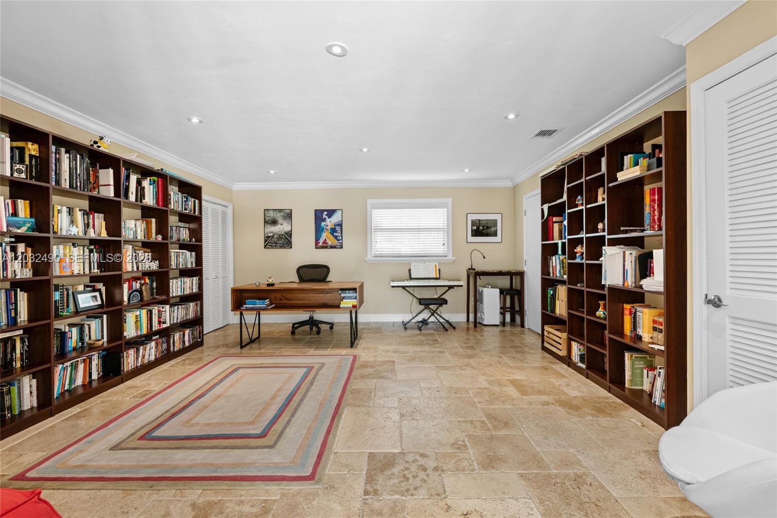 7360 Southwest 115th Street Pinecrest, FL 33156 - Photo 11 of 18 a living room with furniture and a book shelf