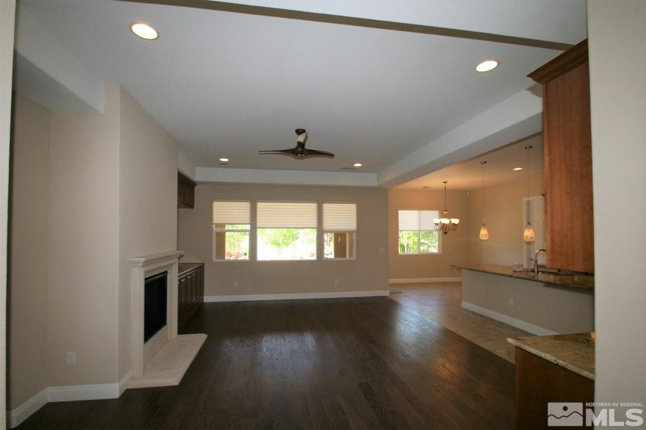 2098 Blue Boy Lane Reno, NV 89521 - Photo 3 of 26 wooden floor in an empty room with a window