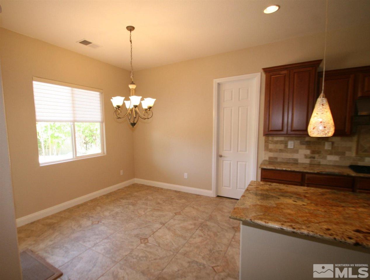 2098 Blue Boy Lane Reno, NV 89521 - Photo 8 of 26 a view of a kitchen with a dishwasher cabinets and a wooden floor