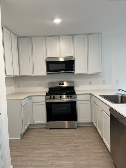 913 Pertuso Lane Huffman, TX 77336 - Photo 4 of 36 a kitchen with granite countertop a stove and a sink