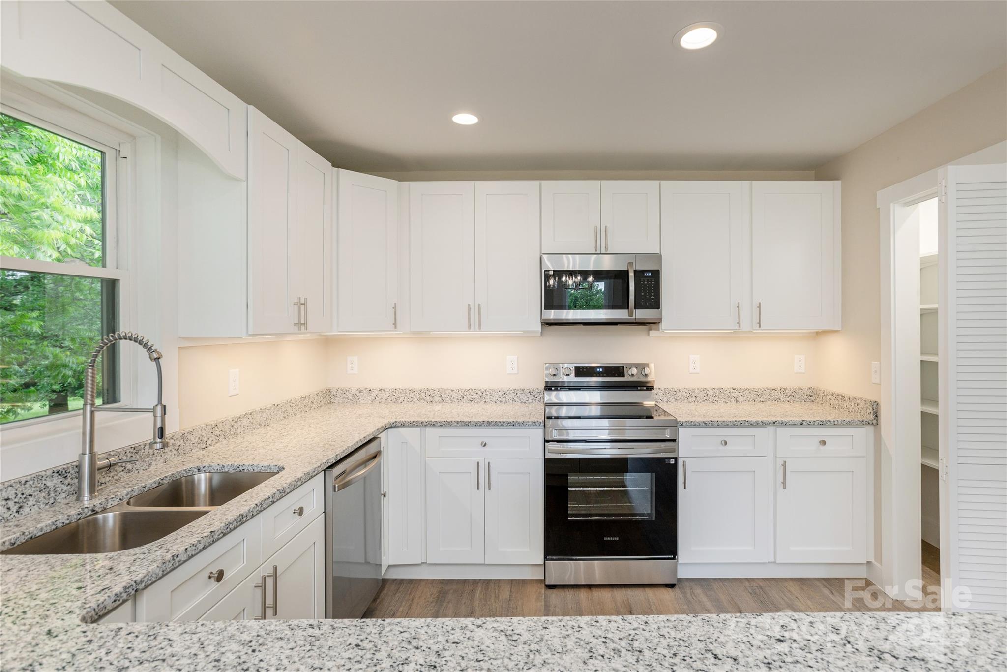 782 Poors Ford Road Rutherfordton, NC 28139 - Photo 12 of 25 a kitchen with stainless steel appliances granite countertop a sink stove and cabinets
