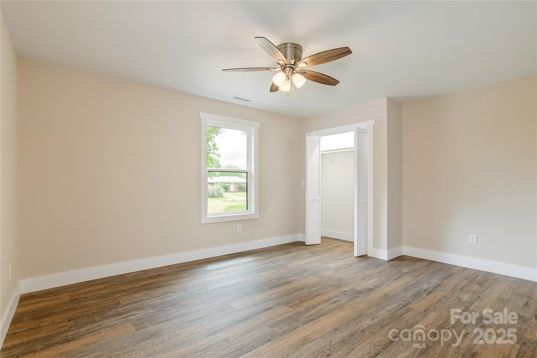 782 Poors Ford Road Rutherfordton, NC 28139 - Photo 21 of 25 a view of an empty room with wooden floor and a window