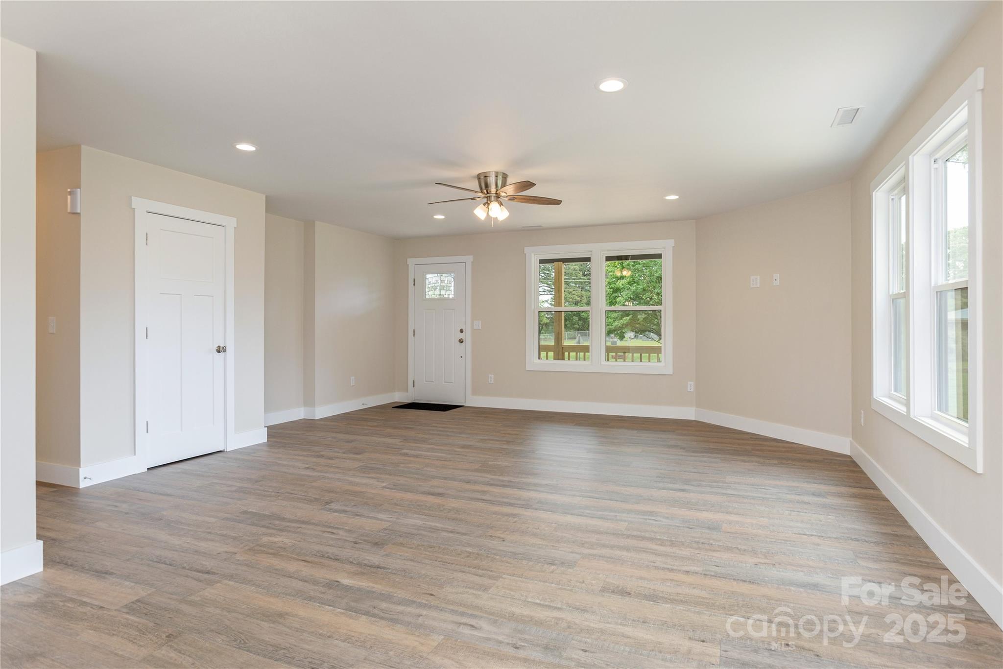 782 Poors Ford Road Rutherfordton, NC 28139 - Photo 4 of 25 an empty room with wooden floor and windows