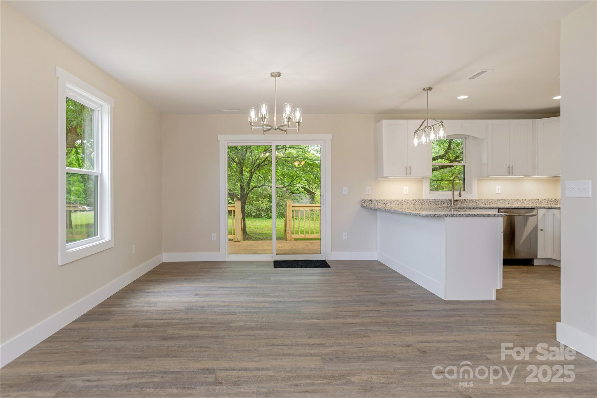 782 Poors Ford Road Rutherfordton, NC 28139 - Photo 7 of 25 a kitchen with kitchen island granite countertop a stove a sink a counter space and a window
