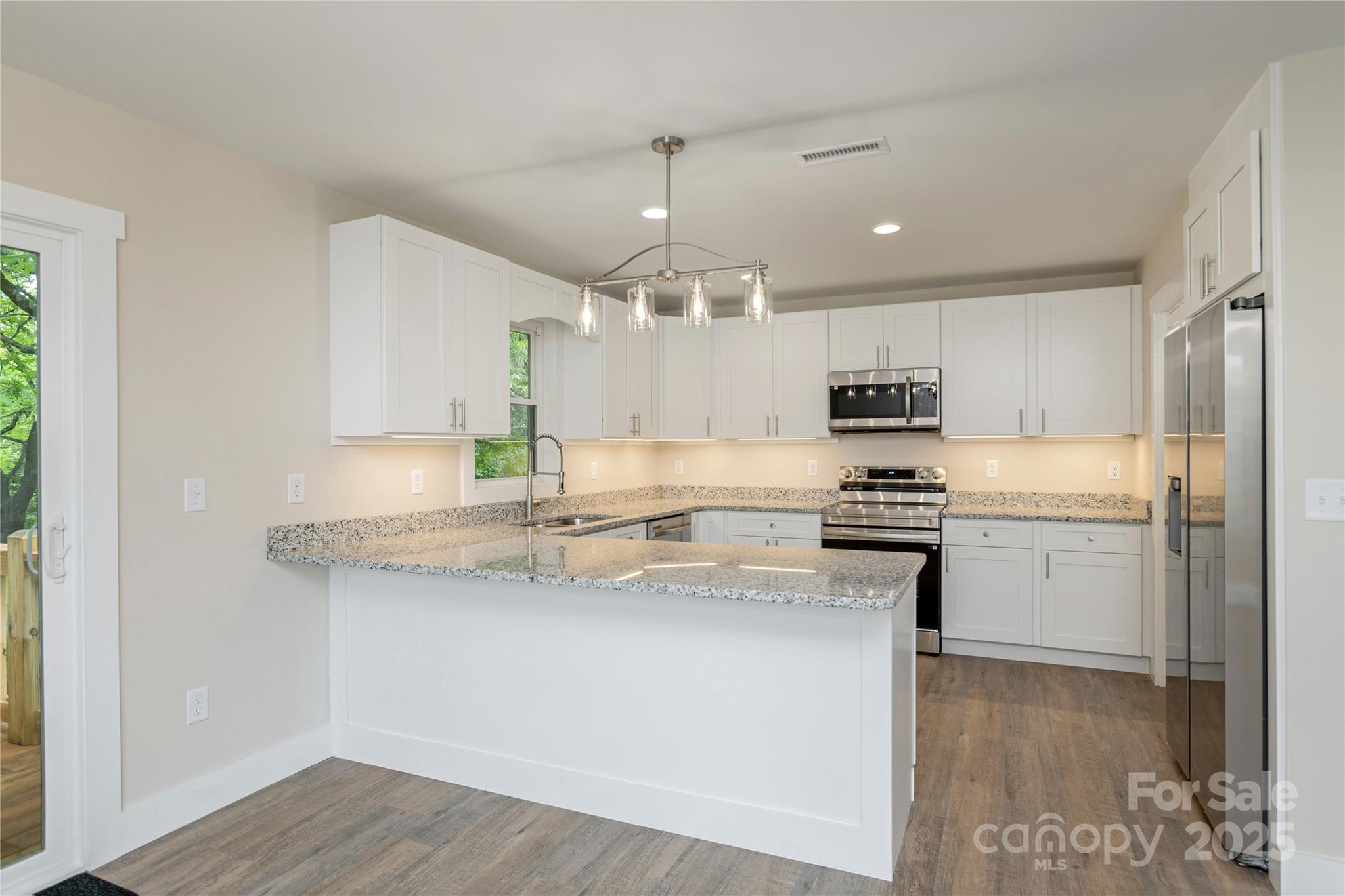 782 Poors Ford Road Rutherfordton, NC 28139 - Photo 8 of 25 a kitchen with stainless steel appliances granite countertop a sink a stove and a refrigerator