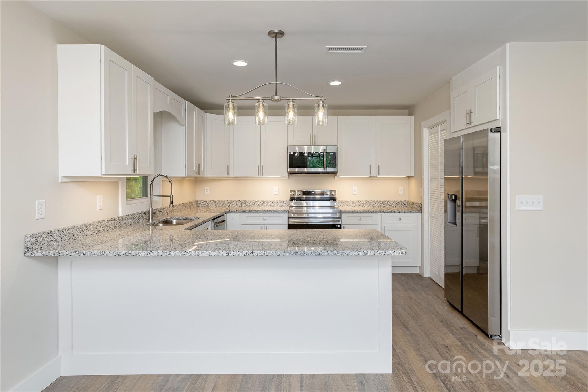 782 Poors Ford Road Rutherfordton, NC 28139 - Photo 9 of 25 a kitchen with stainless steel appliances granite countertop a refrigerator a sink a stove and oven