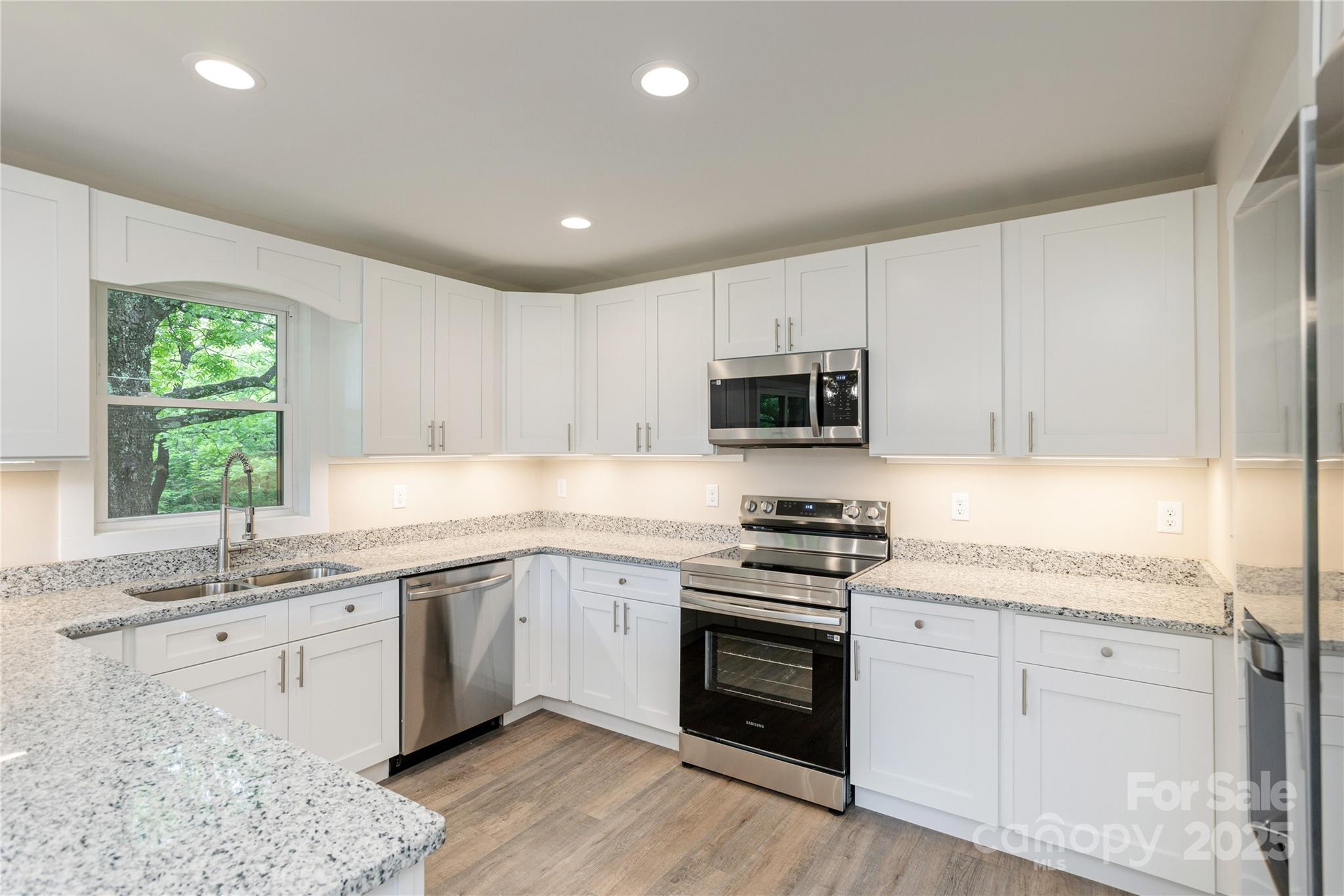 782 Poors Ford Road Rutherfordton, NC 28139 - Photo 10 of 25 a kitchen with granite countertop white cabinets stainless steel appliances a sink and a window