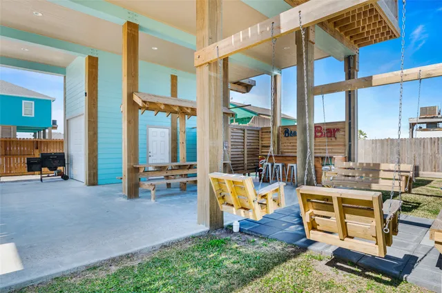a building outdoor space with patio furniture and glass windows