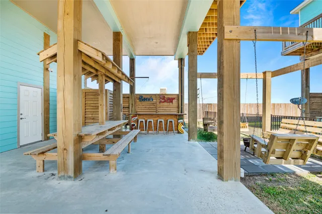 a living room with furniture kitchen view and a flat screen tv