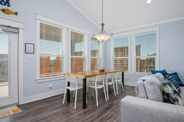 a living room with furniture kitchen view and a chandelier