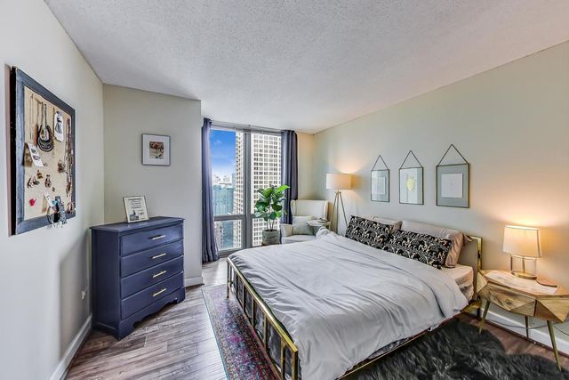 a bedroom with a bed and a dresser