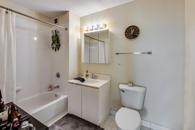 a bathroom with a sink mirror and toilet
