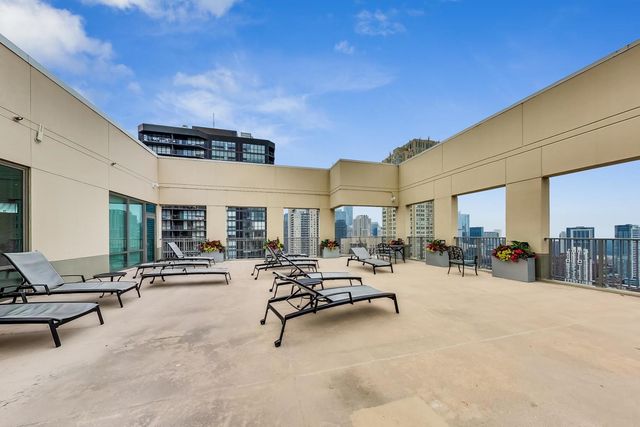 a view of a swimming pool with outdoor seating