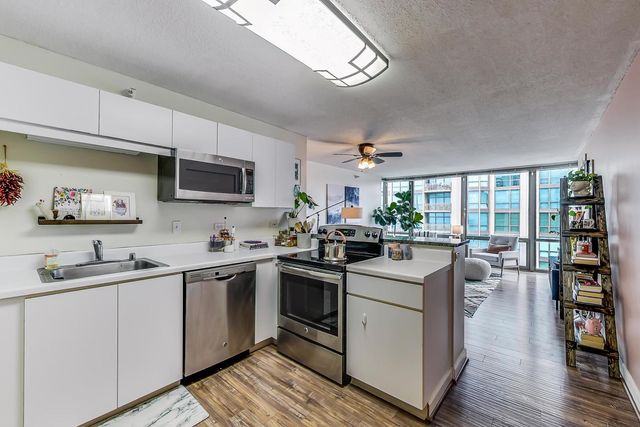 a kitchen with a sink stove and cabinets