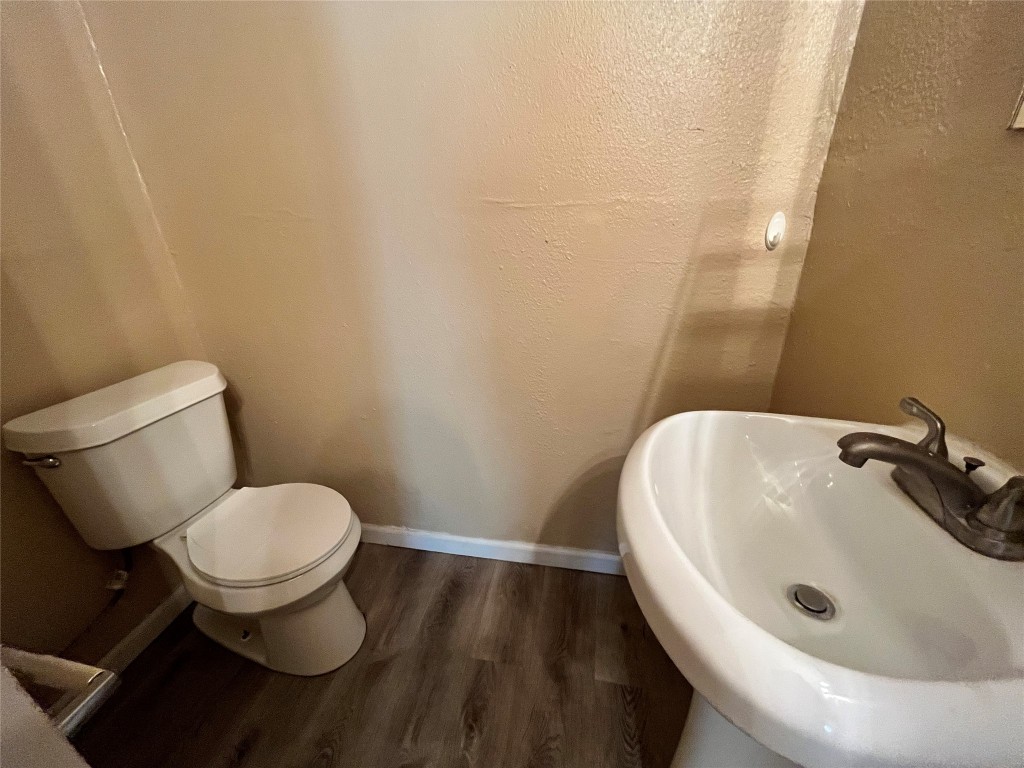 10235 Algiers Road, Unit 2 Houston, TX 77041 - Photo 11 of 12 a bathroom with a sink and a toilet