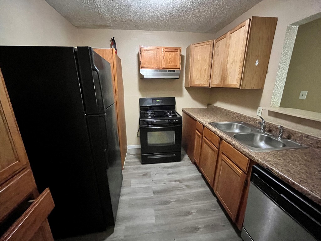 10235 Algiers Road, Unit 2 Houston, TX 77041 - Photo 3 of 12 a kitchen with granite countertop stainless steel appliances a refrigerator and a sink