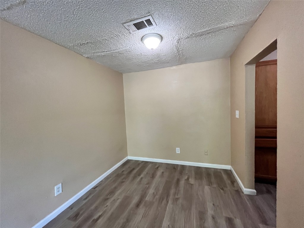 10235 Algiers Road, Unit 2 Houston, TX 77041 - Photo 4 of 12 a view of empty room with wooden floor